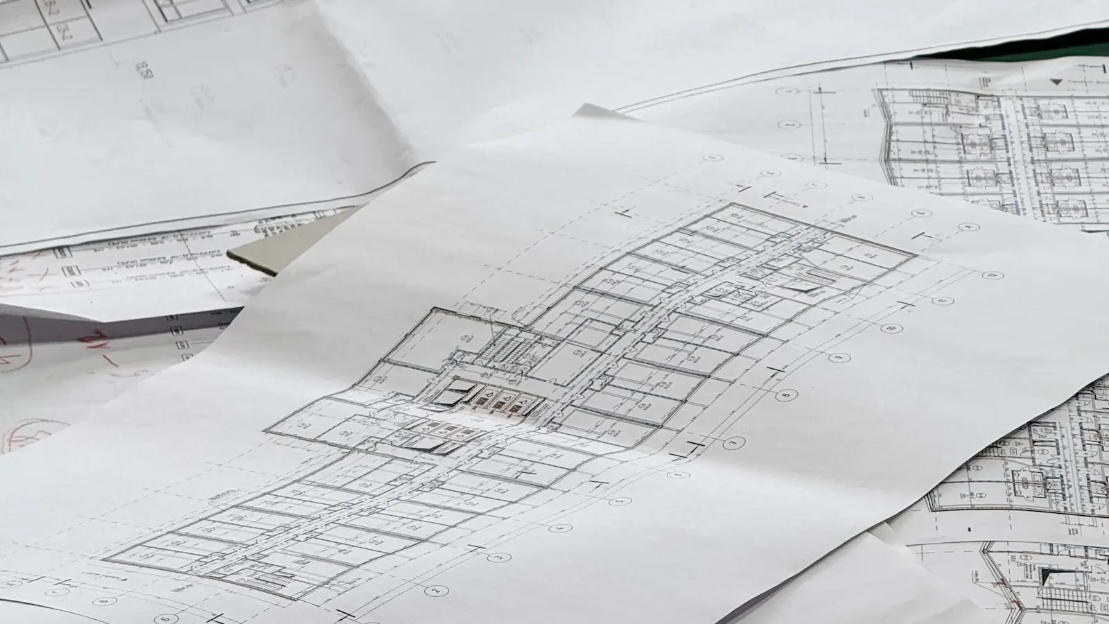 Architectural floor plans spread across a table during the design stage of a home
